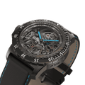 Close-up of RAM Baran Tourbillon R201TS4/1 with skeletonized dial, blue hands, black stainless steel case, and black leather strap.