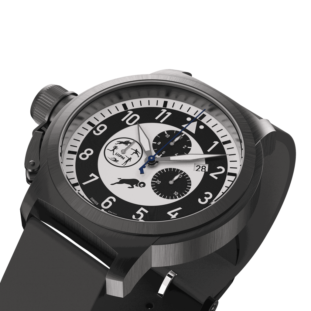 Close-up of black wristwatch with black and white dial, date display at 3 o'clock, and black silicone strap.